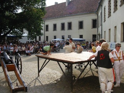The audience gather - I don't believe the gun was needed to keep them quiet!